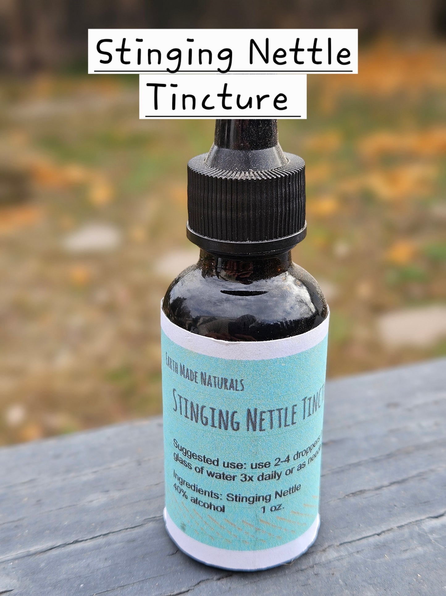 Bottle of Stinging Nettle Tincture with a label on a wooden surface.
