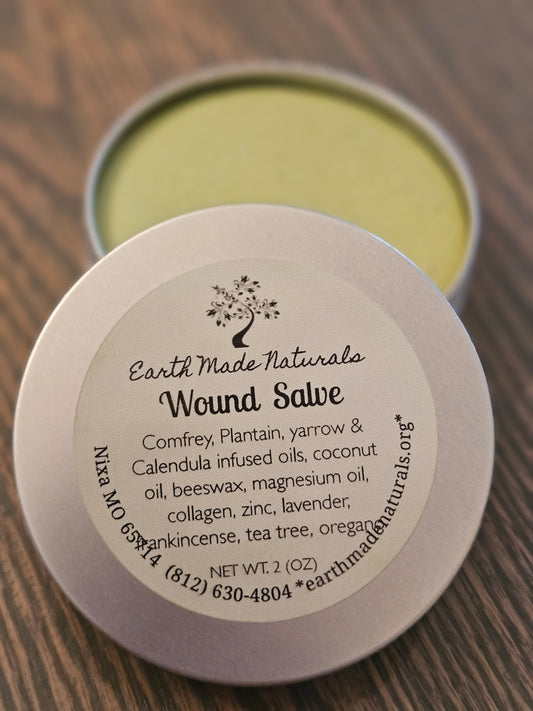 Green Wound salve in a tin with a labeled lid on a wooden surface