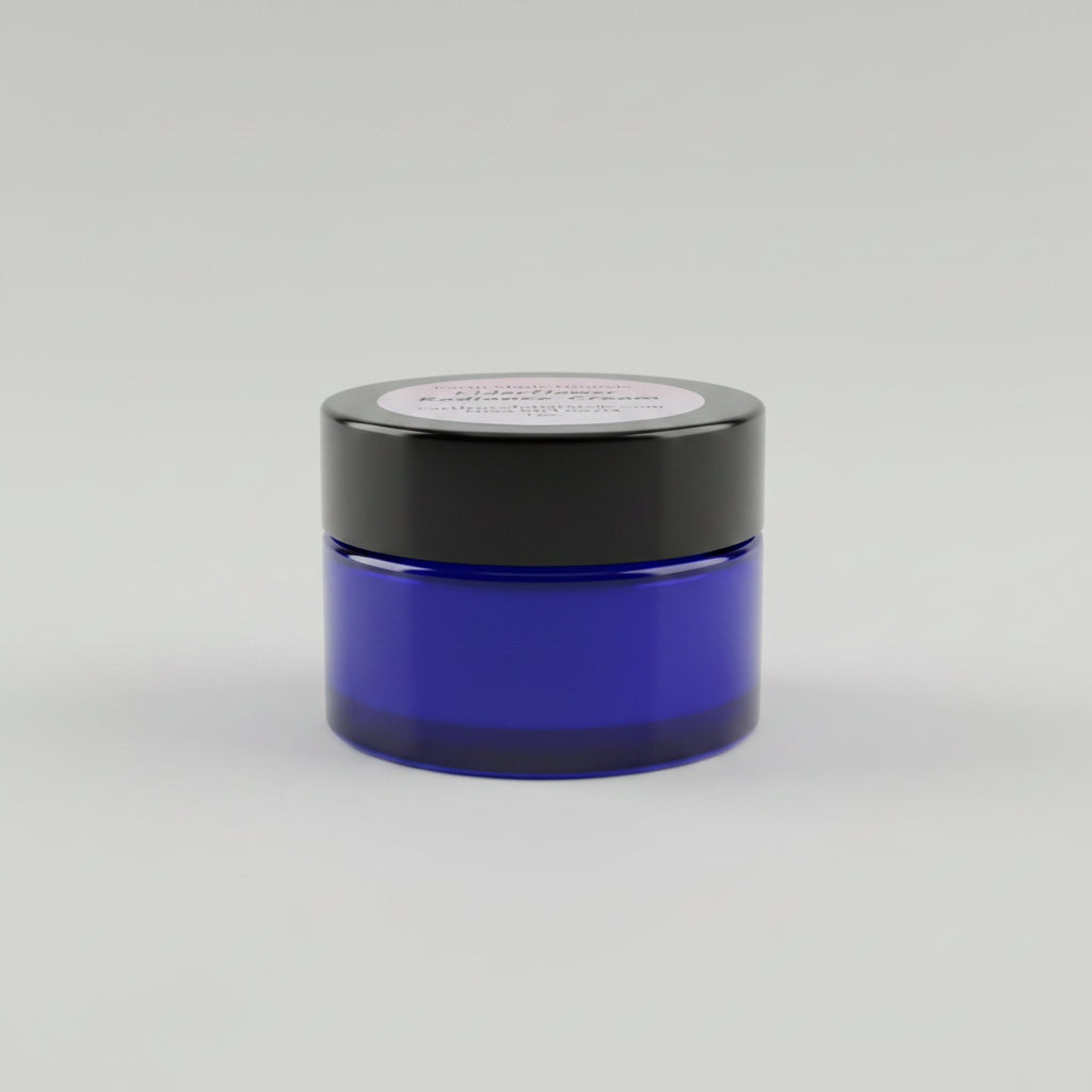Blue jar of Elderflower Radiance Cream on a wooden surface