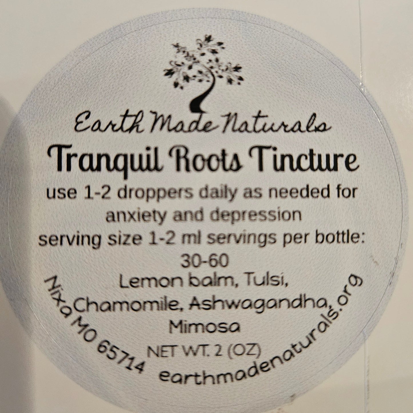 Round label  of tranquil roots tincture with text on a white background