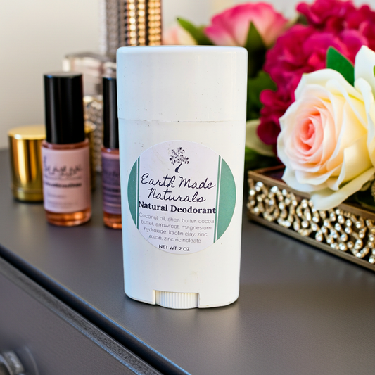 Earth Made Naturals natural deodorant stick on a dresser with flowers and other products in the background