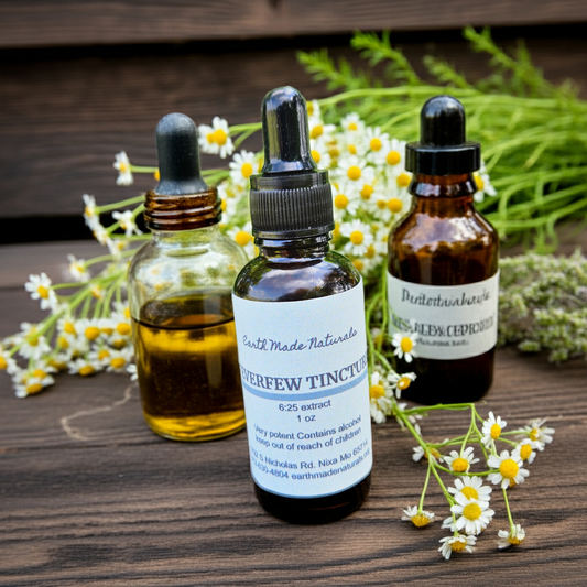 Feverfew  tincture bottles with labels on a wooden surface with flowers around them