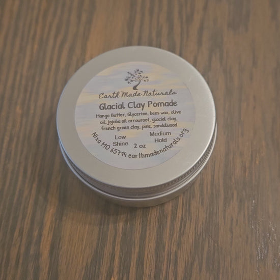 tin of glacial marine hair pomade on a wooden surface
