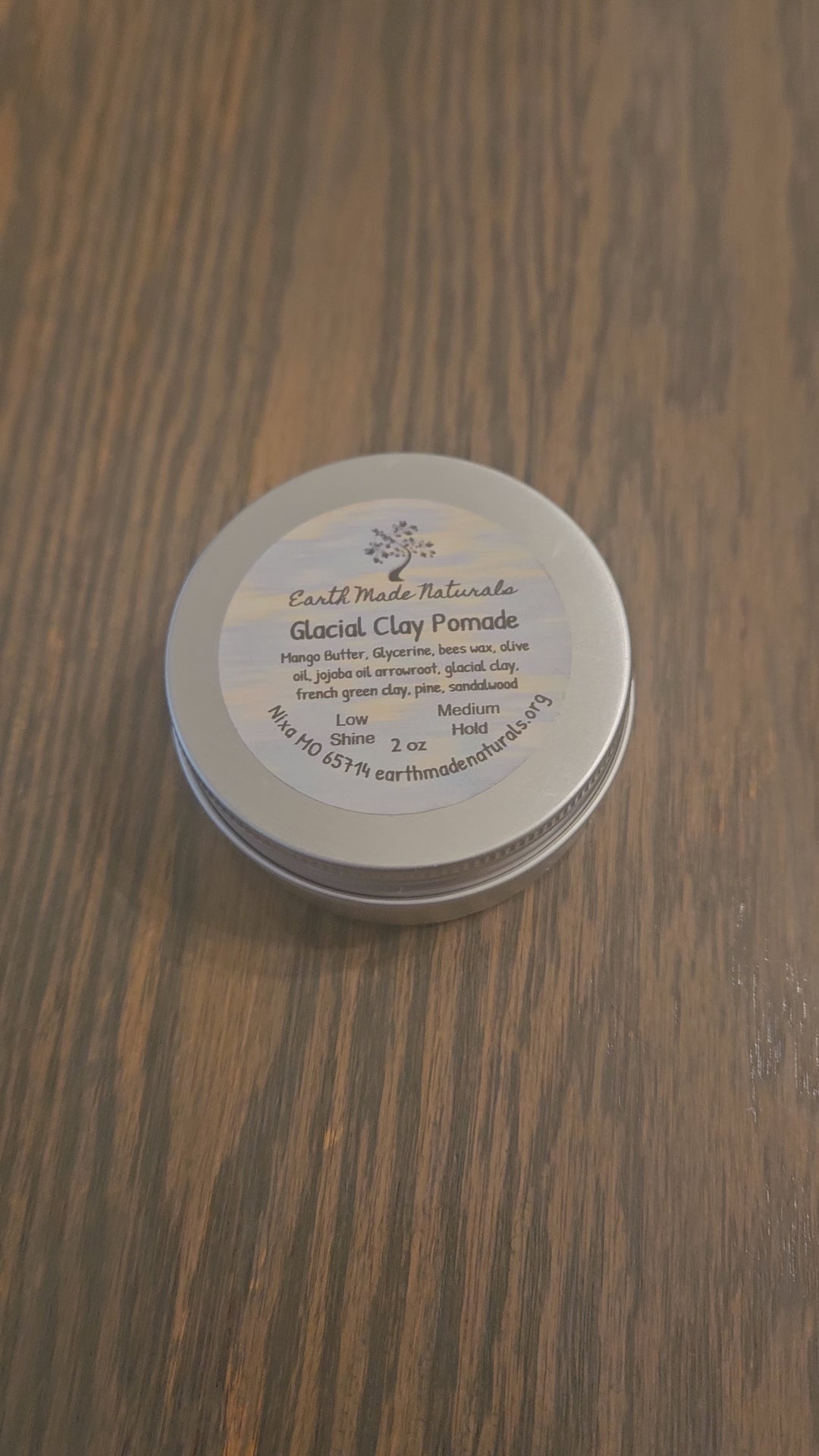 tin of glacial marine hair pomade on a wooden surface
